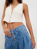Plisserede jeans med knapper foran