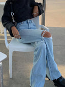 Jeans di jeans strappati alla moda a gamba larga svasata