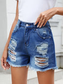 Shorts estivi in denim sfrangiato e consumato