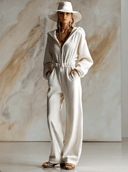 Lässiger weiter modischer weißer Cord-Jumpsuit mit Kapuze, Frontreißverschluss und langen Ärmeln
