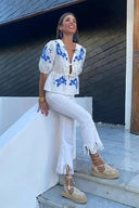 Blusa peplum con fiocco floreale